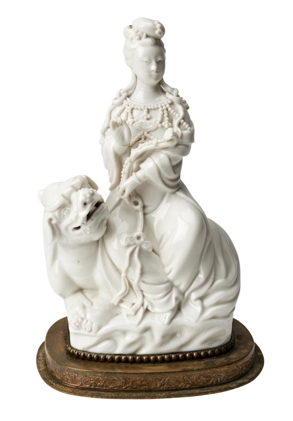 BLANC DE CHINE GROUP&nbsp; LATE QING / REPUBLIC PERIOD modelled as Guanyin seated on a Buddhist lion