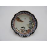 JAPANESE IMARI ENAMELLED LOBED DISH 18TH CENTURY depicting mountain and pagoda scenery 15cm wide