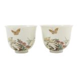 PAIR OF FAMILLE ROSE WINE CUPS finely painted with butterflies over rocky outcrops, apocryphal