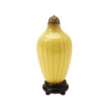 PEKING YELLOW GLASS SNUFF BOTTLE QING DYNASTY of lobed baluster form, with a gilt-bronze stopper and