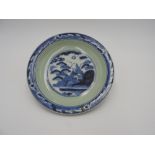 JAPANESE BLUE AND WHITE DISH 18TH / 19TH CENTURY painted with a pagoda within a verdant landscape