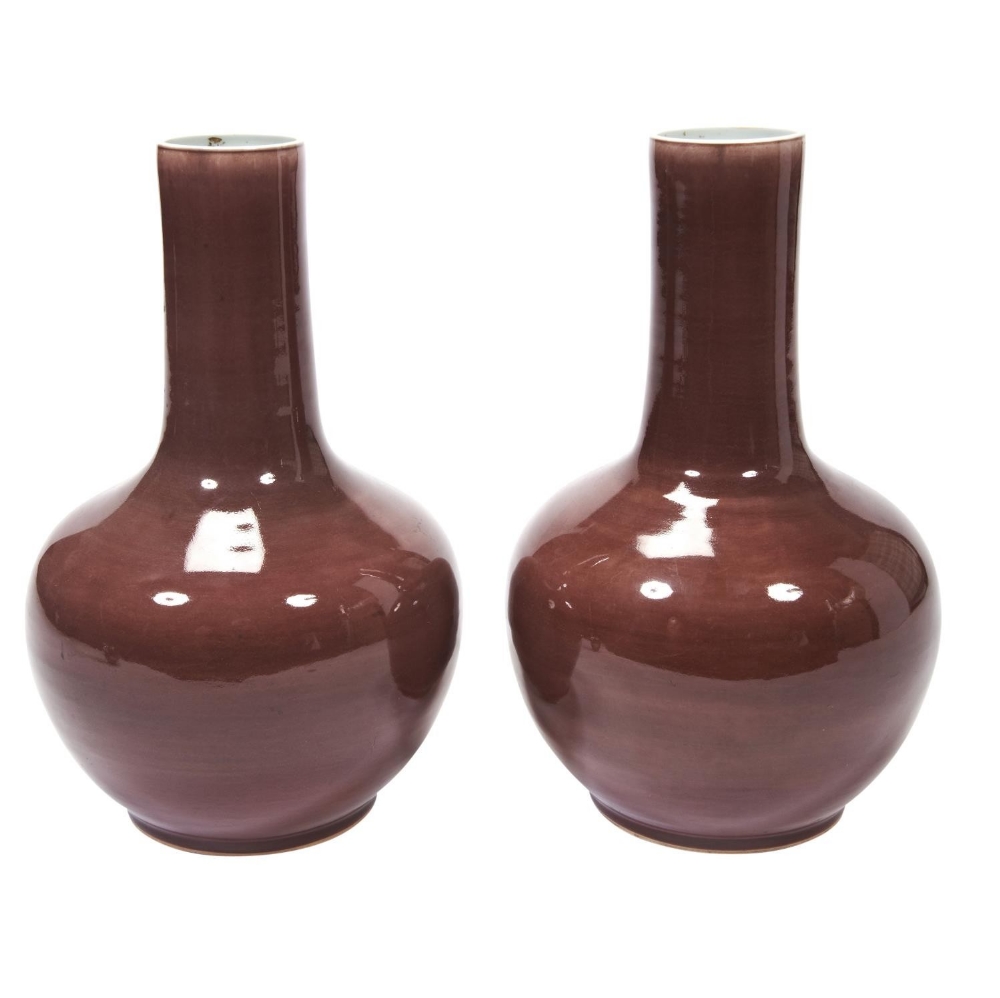 FINE PAIR OF COPPER-RED GLAZED BOTTLE VASES  QING DYNASTY, 18TH CENTURY covered in a rich red glaze 