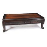 CHINESE HARDWOOD LOW TABLE 20TH CENTURY fitted with three frieze drawers, raised on squat mask