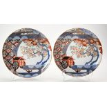 PAIR OF IMARI PLATES LATE EDO PERIOD unusually decorated with a coach beneath blossoming prunus