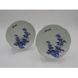 PAIR OF IMARI BLUE AND WHITE ROBED DISHES 18TH CENTURY painted with stylised flowers and butterflies