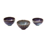 THREE 'JUN' WARE BOWLS 20TH CENTURY each covered in a rich purple/turquoise glaze 9cm and 10cm diam