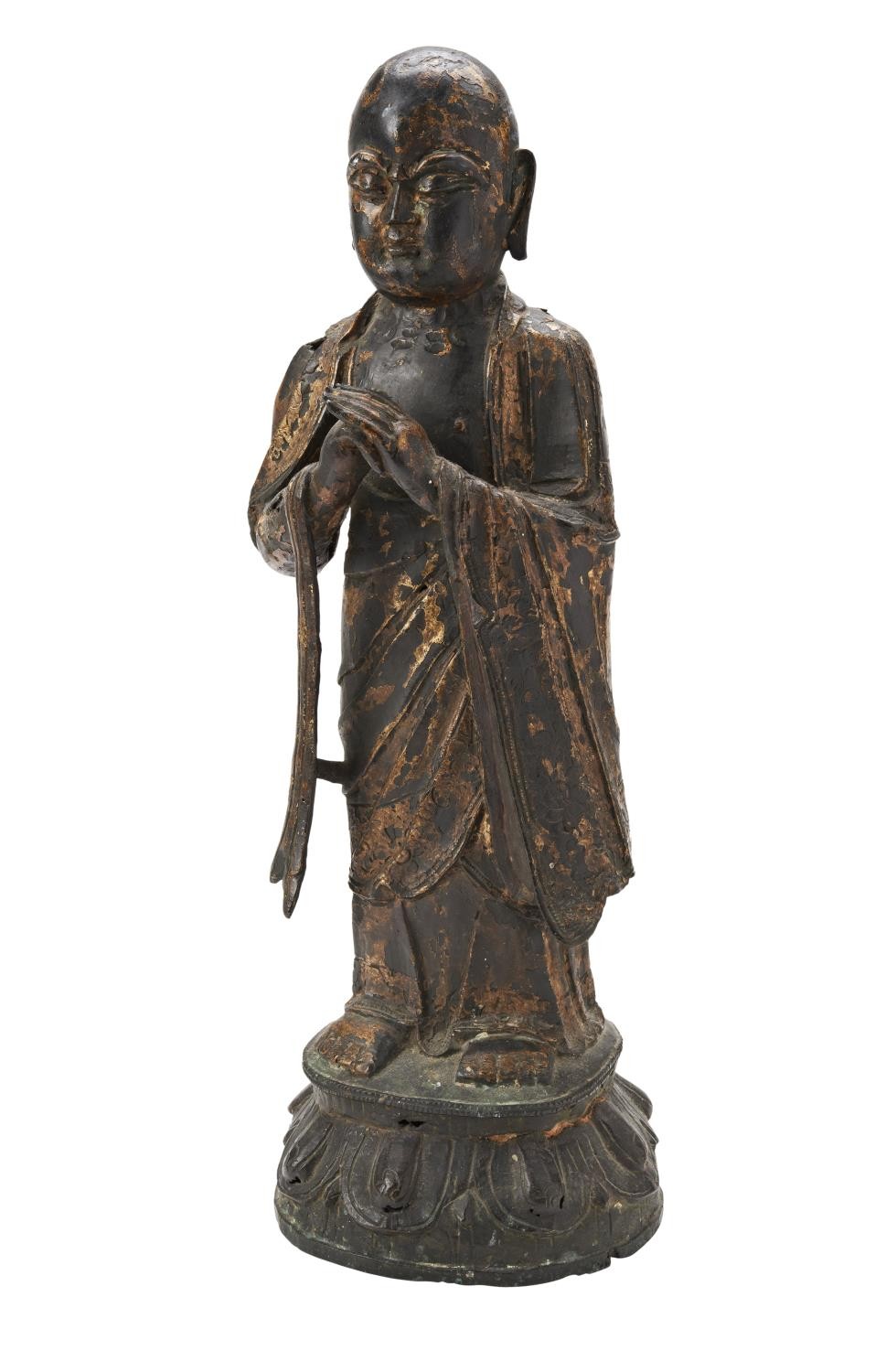 GILT-BRONZE FIGURE OF A MONK MING DYNASTY the standing figure wearing patchwork robes, open at the c