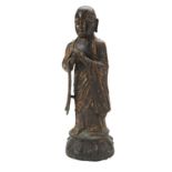 GILT-BRONZE FIGURE OF A MONK MING DYNASTY the standing figure wearing patchwork robes, open at the