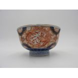 JAPANESE IMARI ENAMELLED BOWL EDO PERIOD painted in underglaze blue and gilt with a floral roundel