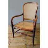 VICTORIAN MAHOGANY CANE SEAT ELBOW CHAIR, with turned stretcher bar support on turned splayed