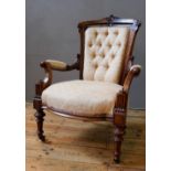 LATE VICTORIAN WALNUT FRAME ARMCHAIR, UPHOLSTERED BUTTON BACK WITH TAPERED FLUTED FRONT LEGS