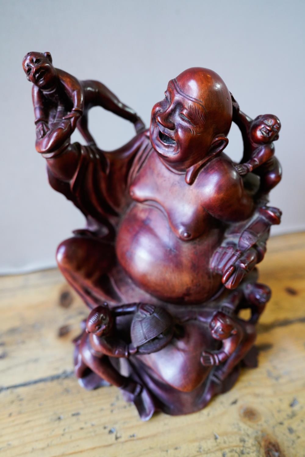 CHINESE CARVED HARDWOOD SEATED BUDDHA 20TH CENTURY raised on a fitted stand 36cm high 