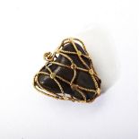 GOLD ENCASED BEZOARS STONE PENDANT the bezoars stone encased in twisted gold cage