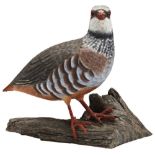 A FIGURE OF A RED LEGGED PARTRIDGE on a wooden base with branded mark ?M W?, a grey partridge, a