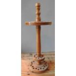 A 20TH CENTURY WOODEN CIRCULAR WALKING STICK STAND with two concentric sets of holes 87 cm high