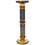 A CONTINENTAL CASED GLASS COLUMN the deep amber casing cut to lighter long facets, central collar,