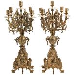 AN ORNATE BRASS CANDLE GARNITURE 20TH CENTURY of five nozzles over decorative bases with rampant