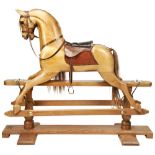 A STEVENSON BROTHERS TRESTLE ROCKING HORSE IN NATURAL WOOD FINISH brown mane and tail, brown harness