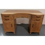 A BLEACHED WOOD DRESSING TABLE, a 1930s lowboy with two doors and a lowboy with bank of small