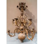 A PIERCED BRASS 12 BRANCH ORNATE BALUSTER CENTRAL LIGHT FITTING with floriform detailing  95cm high