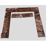 A VICTORAN MARBLE FIREPLACE of variegated brown and white colouration with black appliques (with two