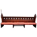 A SPECTACULAR VICTORIAN OAK PEW circa 1880, the end boards carved with medieval style terminals