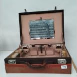 A LEATHER TRAVELLING VANITY CASE C.1925 WITH CANVAS TRANSIT COVER 14 cm x 40 cm x 30 cm