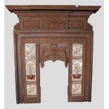 A VICTORIAN CAST IRON FIRE SURROUND WITH ORNATELY CAST RAISED OVERMANTEL SECTION and tiled side