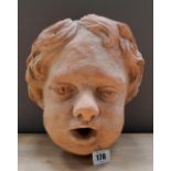 CONTEMPORARY TERRACOTTA WALL FOUNT DEPICTING PUTTO 24cm x 28cm