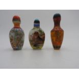 THREE CHINESE PAINTED GLASS SNUFF BOTTLES 20TH CENTURY with apocryphal Qianlong marks largest, 9cm