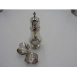 HALL MARK SILVER SUGAR CASTER AND TWO HALL MARK SILVER NAPKIN RINGS, caster 16cm high 4oz total