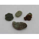 FOUR CHINESE HARDSTONE CARVINGS 20TH CENTURY comprising two pendants, a buckle, and a shell largest,