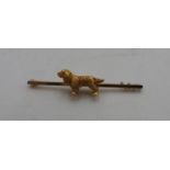 A GOLD COLOURED COCKER SPANIEL STOCK PIN, the textured cocker spaniel on a bar brooch stamped