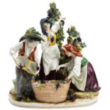 A CONTINENTAL PORCELAIN FIGURE GROUP of grape pickers featuring a man and two women, probably