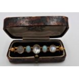 A 9ct GOLD MOONSTONE AND OPAL SET BAR BROOCH