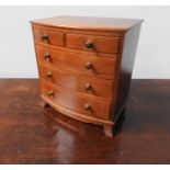 MINIATURE TABLE TOP BOW-FRONT HARDWOOD CHEST OF FIVE DRAWERS
