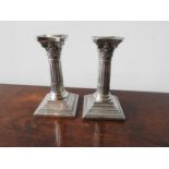 A PAIR OF HALLMARK SILVER CORINTHIAN PILLAR STYLE CANDLESTICKS, Birmingham 1902, 27oz (inc.