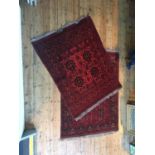 TWO EASTERN BORDER PATTERN RUGS, one badly worn in places 205 x 153cm