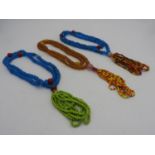 THREE CHINESE GLASS BEAD NECKLACES 20TH CENTURY comprising two blue and the other amber (3)