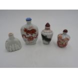 TWO CHINESE IRON-RED DECORATED PORCELAIN SNUFF BOTTLES 20TH CENTURY together with a FAMILLE ROSE