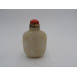 CHINESE CARVED WHITE JADE SNUFF BOTTLE 20TH CENTURY with a coral stopper 8cm high