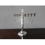 SILVER MENORAH BIRMINGHAM, 1938 raised on a facetted square spreading foot 26cm high
