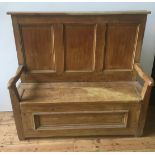 19th CENTURY WAXED PINE PANELLED SETTLE, with lift top seat with storage below 136 x 150 x 53cm