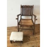 CARVED OAK CANE SEAT CHILD'S ELBOW CHAIR WITH BARLEY TWIST STRETCHER BAR AND PILLARS SUPPORTING