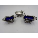 A HALLMARK SILVER MUSTARD POT AND A MATCHING PAIR OF HALLMARK SILVER SALTS, with a pair of silver