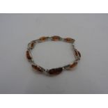 AN AMBER AND SILVER BRACELET