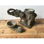 WEATHERED RECONSTITUTED STONE GARDEN FIGURE OF ELEPHANT AND SHOE PLANTER, 48cm high