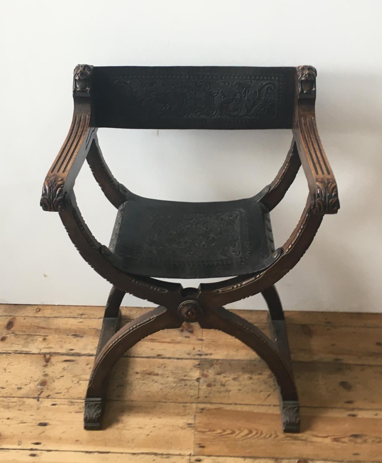19th CENTURY SAVANAROLA FOLDING CHAIR, with ornate embossed leather seat and back panels 89cm high x