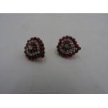 A PAIR OF RUBY AND DIAMOND HEART SHAPED EARRINGS, set with polished bead rubies and brilliant cut