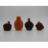 FOUR CHINESE 'AMBER' SNUFF BOTTLES 20TH CENTURY largest, 7cm high, smallest, 4cm high